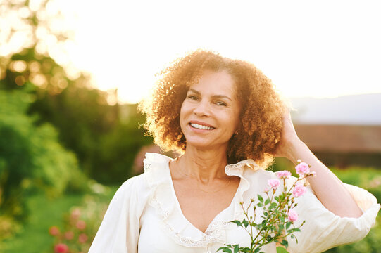 Outdoor close up portrait of beautiful middle age woman at sunset