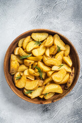 Roasted potato wedges with rosemary, organic vegetarian potato wedges meal. White background. Top view
