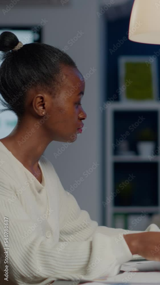 Poster black manager analysing graphics and financial statistics from documents working overtime in front o
