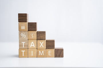 Wooden block tax time planning prepare financial statement scheduling research report and reviews, check tax payment earning tax return income and expenses for individuals and business, graphical icon