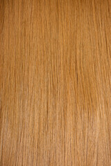 Red hair close-up as a background. Women's long orange hair. Beautifully styled wavy shiny curls. Hair coloring bright shades. Hairdressing procedures, extension.