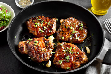 Fried pork steaks in cooking pan