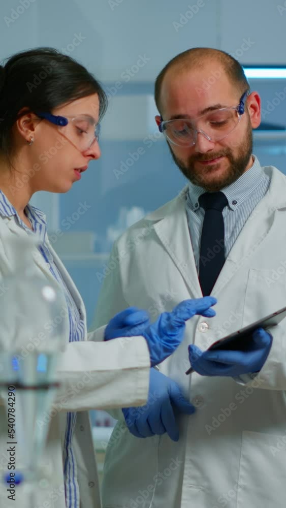 Aufkleber vertical video: scientist team meeting and discusssing treatment results standing in research labora