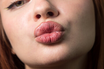 Air kiss with female lips close-up. Close-up portrait of a woman