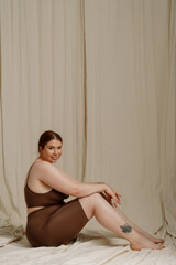 White young woman smiling and posing while standing isolated