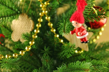Spruce branches with bright wooden toys and a garland.