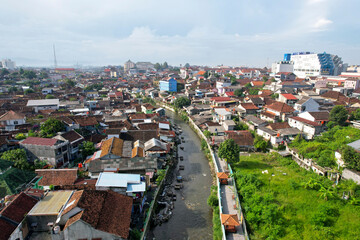Fototapeta na wymiar Malioboro Yogyakarta street view from above is a landmark of Yogyakarta Indonesia Toursim, Rush Hour Traffic with Train. KRL Yogyakarta