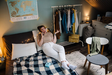 Young beautiful girl talking phone, gesturing and looking aside