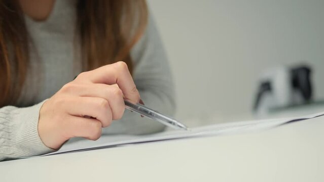 Close-up: woman lawyer office worker proofreading a contract before signing