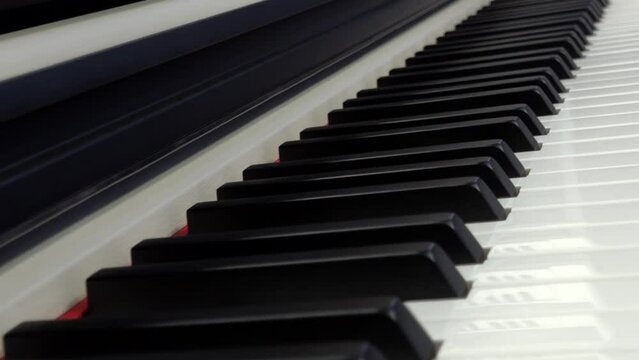 Piano keys close-up. The camera moves over the piano keys