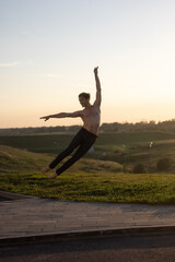 Summer activity and energy. Ballet dancer. Handsome man workout and stretching. fitness Coach and health. Sport and yoga. Pilates for man. Nature background. Young man. Ballet dancer. Green grass. 