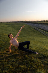 Summer activity and energy. Ballet dancer. Handsome man workout and stretching. fitness Coach and health. Sport and yoga. Pilates for man. Nature background. Young man. Ballet dancer. Green grass. 