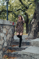 portrait of a woman walking down the stairs in a park