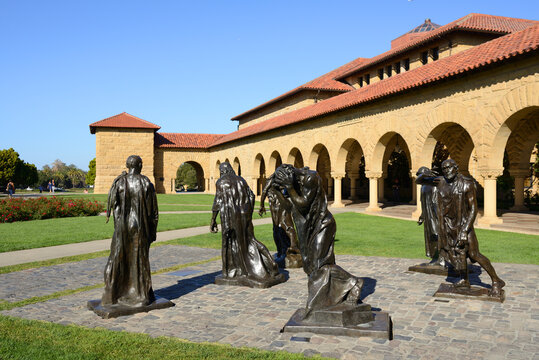 Bronze statues by Auguste Rodin Burghers of Calais in Memorial Court in sunny day. Stanford University, California, United States