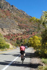 Fototapeta premium Man ride his road bike along the mountain road, Big Cottonwood Canyon, Salt Lake City, Utah