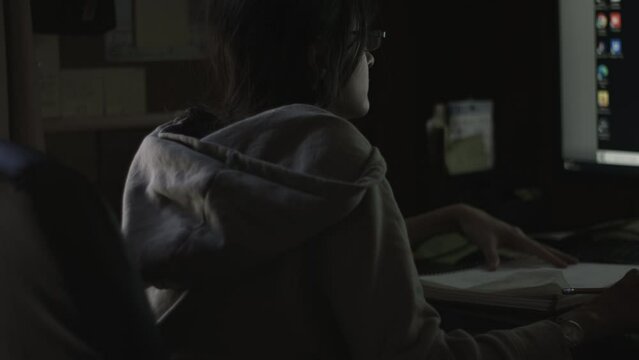 Young Female Office Employee Carries Out Daily Tasks at Her Desk 4K