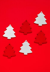 Fototapeta na wymiar Set of retro red and white wooden Christmas tree toys on a red background. Copy space.