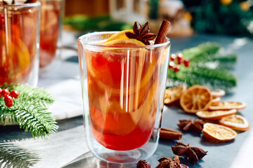 Christmas mulled wine with aromatic spices and citrus fruits. Traditional Christmas festive warming drink with orange, cinnamon, cardamom and anise.