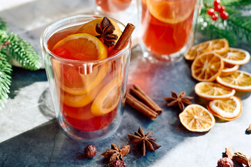 Christmas mulled wine with aromatic spices and citrus fruits. Traditional Christmas festive warming drink with orange, cinnamon, cardamom and anise.