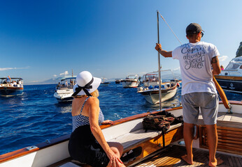 woman and yacht captain surveying boats off Capri