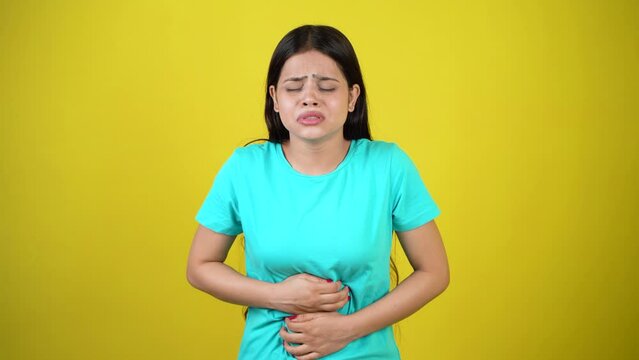 Woman suffering from stomach ache and nausea on color background