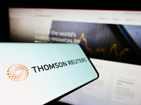 Stuttgart, Germany - 10-14-2022: Smartphone with logo of Canadian media company Thomson Reuters Corporation on screen in front of website. Focus on center of phone display.
