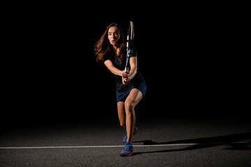 woman tennis player holds tennis racket in her outstretched forward arms prepares to play