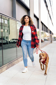 Young Woman Walking her Dog