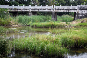 Fototapeta na wymiar Highway bridge across a river stream in rural area.