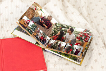 Obraz na płótnie Canvas christmas and young family in retro photo book