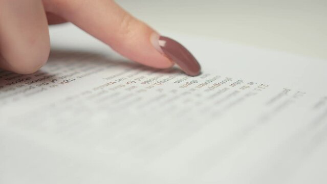 Close-up: woman lawyer office worker proofreading a contract before signing