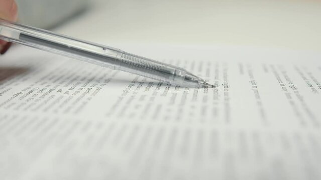 Close-up: woman lawyer office worker proofreading a contract before signing