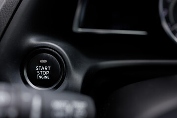The engine start and stop button for modern car engine ignition. Keyless technology concept.