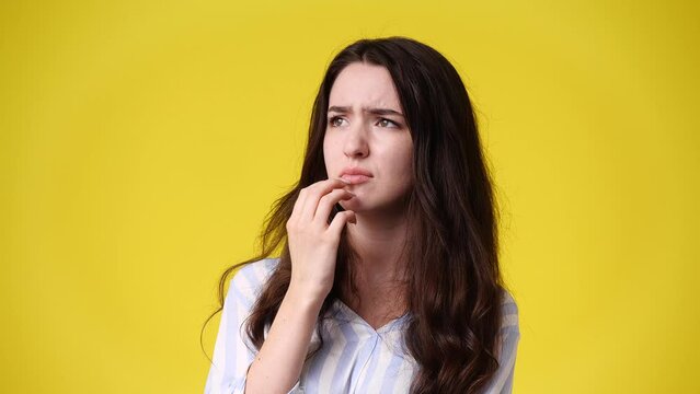 4k video of upset woman isolated over yellow background.