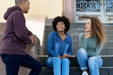 Group of happy hispanic and caucasian and african american young adults