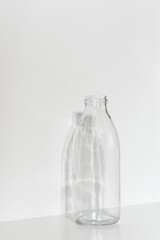 Glass bottle on a light background. Zero waste concept.