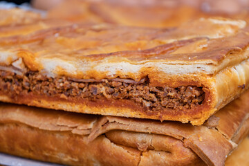 Delicious flour dough stuffed with spicy baked meat.