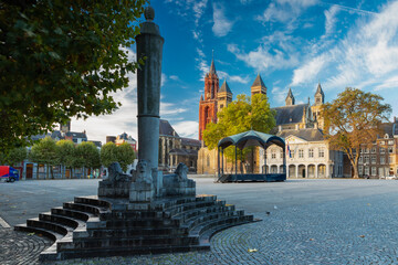 Maastricht, Netherlands 10-24-2022 An empty vrijthof square in downtown Maastricht with a dramatic cloudscape and the typical skyline withthe Servaas baslicia, red tower of Sint Jan and Perroen statue