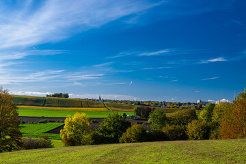 Autumn view of a valley in Maastricht with an beautiful cloudscape with fluffy clouds of a rolling hill landscape with vineyards in the South of the Netherlands 