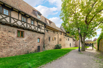 Fototapeta na wymiar The fortified medieval wall and towers in the picturesque French village of Riquewihr, France, one of the stops along the wine route in the Alsace region. 
