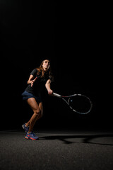 woman tennis player with strong legs on tennis court with racket.