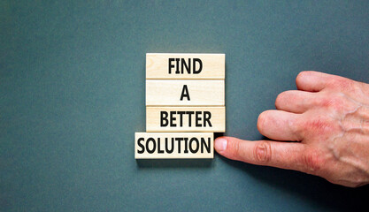 Find a better solution symbol. Concept words Find a better solution on wooden blocks. Beautiful grey table grey background. Businessman hand. Business find a better solution concept. Copy space.