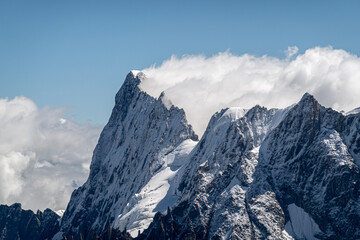 The peak of Grandes Jorasses emerging from the clouds