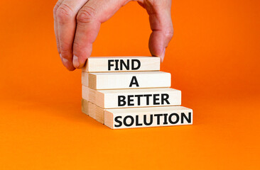 Find a better solution symbol. Concept words Find a better solution on wooden blocks. Beautiful orange table orange background. Businessman hand. Business find a better solution concept. Copy space.