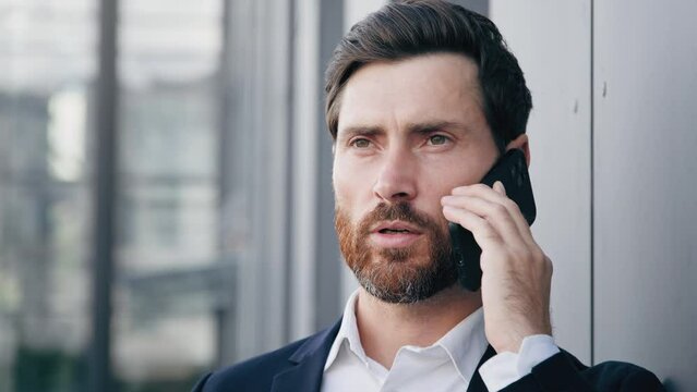 Portrait serious man talking on mobile phone answering business call successful businessman professional manager agent consultant communicate remote using smartphone advises client speaks with partner