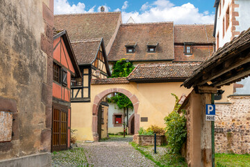 Fototapeta na wymiar The Court of the Bishops of Strasbourg in the medieval village of Riquewihr, France, one of the stops along the wine route in the Alsace region.