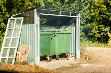Standard containers for collecting unsorted waste are installed in a specially designated place.