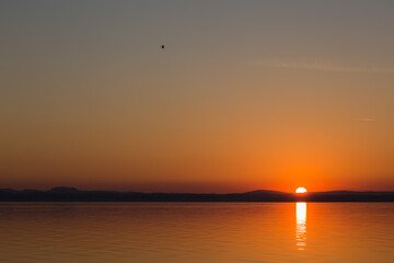 Distant and minimalistic sunset on a lake