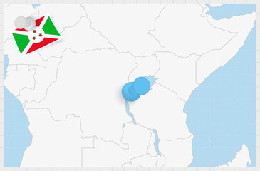 Map of Burundi with a pinned blue pin. Pinned flag of Burundi.