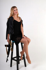 Beautiful woman with assault rifle at the chair
